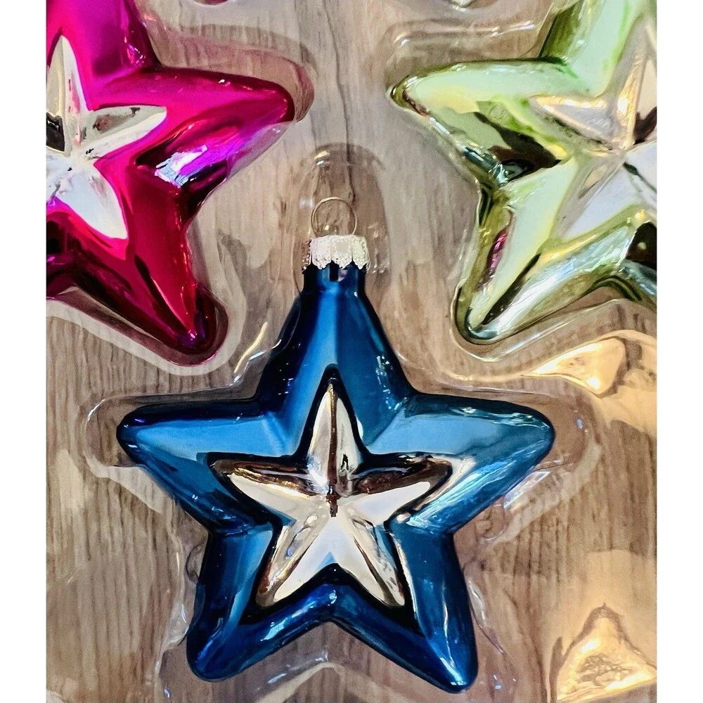 Handcrafted Glass Ornament Set features four star-shaped ornaments metallic